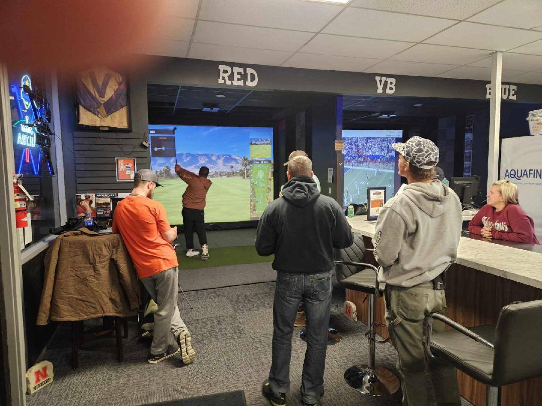 Guests gathered around simulator bay