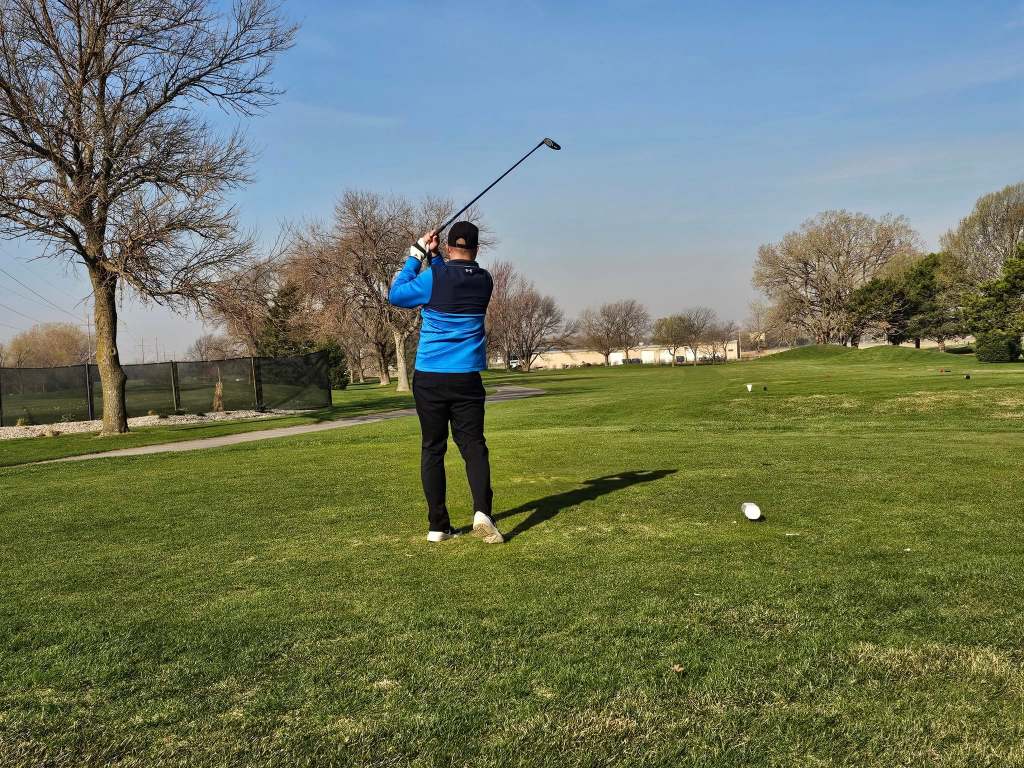 Golfer teeing off on golf course